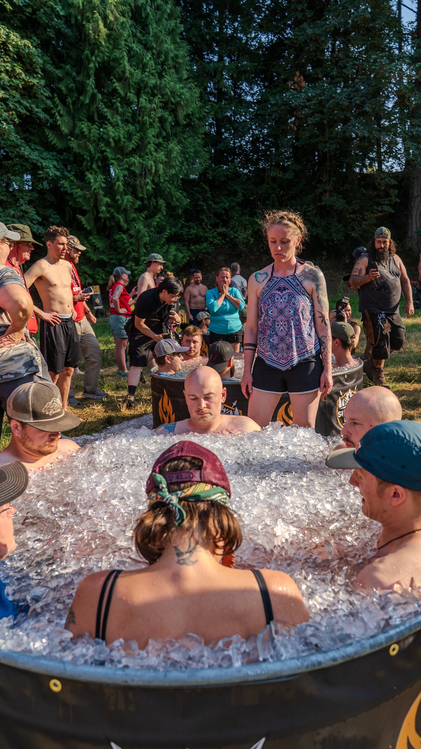 Competitors in an ice bath as others watch during the 2026 PNW Survival Games